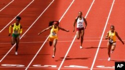 FILE - North Carolina A&T's Cambrea Sturgis, right, wins the women's 100 meters during the Division I Outdoor Track and Field Championships, June 12, 2021, at Hayward Field in Eugene, Ore.