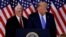 FILE - U.S. President Donald Trump and Vice President Mike Pence react to early results from the 2020 U.S. presidential election, at the White House in Washington, Nov. 4, 2020. YouTube has said it will no longer remove content containing misinformation on the 2020 election. 