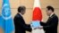 Rafael Grossi, Director-General of the IAEA, left, presents IAEA's comprehensive report on the Fukushima Treated Water Release to Japanese Prime Minister Fumio Kishida, at the prime minister's office, July 4, 2023, in Tokyo.