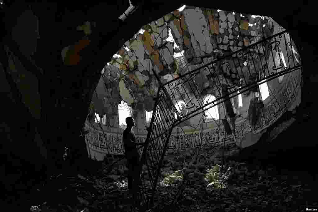 A Palestinian man inspects the site of an Israeli strike on a mosque in Khan Younis in the southern Gaza Strip. REUTERS/Ibraheem Abu Mustafa