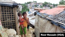 FILE - An eight-year-old Rohingya refugee girl with her one-and-a-half-year-old brother at a camp in Cox's Bazar, Bangladesh.