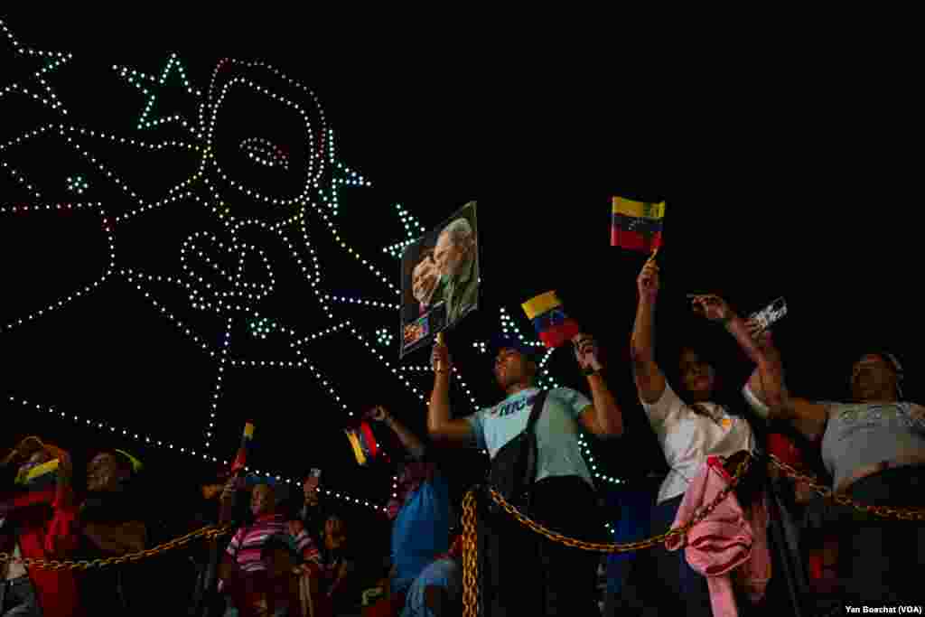 Supporters of Nicolas Maduro celebrate the Venezuelan president&#39;s re-election announcement at the Miraflores Palace, while drones draw the face of the Chavista leader in the skies above Caracas, July 29, 2024.