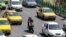 FILE - Iranian commuters drive in the capital, Tehran, on Aug. 13, 2022. Government workers are having to begin their commutes much earlier now, thanks to a revision in schedules aimed at reducing energy consumption when power consumption peaks.
