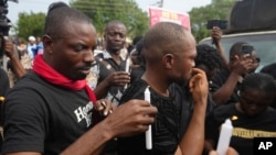 FILE - People light candles during a procession in honor of all protesters killed nationwide at recent economic hardship protests, in Lagos, Nigeria, Aug. 9, 2024. 