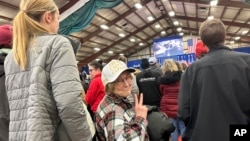 Jackie Garlock of Clear Lake, Iowa, wears a white hat indicating her status as one of Donald Trump's "caucus captains" while attending his rally in Mason City, Iowa, Jan. 5, 2024. 