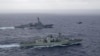 资料照片：美国海军导弹驱逐舰“钟云号”与加拿大皇家海军护卫舰“蒙特利尔号”在南中国海进行演习期间并肩航行。（2023年5月30日）