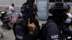 (FILE) Police on a motorcycle leave the Boleita National Police detention center where some people arrested during recent opposition protests against the official results of the presidential election are held in Caracas, Venezuela, Aug. 1, 2024.