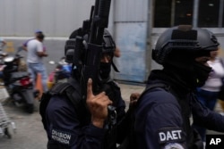 Police on a motorcycle leave the Boleita National Police detention center where some people arrested during recent opposition protests against the official results of the presidential election are held in Caracas, Venezuela, Aug. 1, 2024.