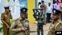 Police and navy personnel stand guard as presidential candidates file nomination papers for the upcoming presidential elections outside the Election Commission office in Colombo, Sri Lanka, on Aug. 15, 2024.