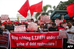 Trade union members protest over the government's debt restructuring affecting the income of the pension funds, in Colombo on July 25, 2023.