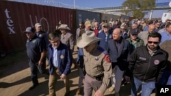 U.S. House Speaker Mike Johnson, center left, and Texas Department of Public Safety Chief Steve McCraw, center right, lead a group of Republican members of U.S. Congress during a tour of the Texas-Mexico border, in Eagle Pass, Texas, Jan. 3, 2024.