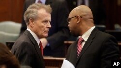 FILE -Illinois Speaker of the House Michael Madigan, left, speaks with Illinois Representative Thaddeus Jones, Nov. 7, 2013, in Springfield, Illinois. A reporter received several tickets for persistent questioning of Calumet City officials, including Jones, who is the mayor.