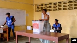 A woman casts her ballot in the second round of presidential elections in Monrovia, Liberia, Nov. 14, 2023. Liberian President George Weah conceded defeat late Friday after provisional results from this week's runoff vote showed challenger Joseph Boakai beating him.