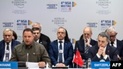 Head of the Ukrainian President's Office Andriy Yermak, left, and Swiss Foreign Affairs Minister Ignazio Cassis attend the 4th meeting of the National Security Advisers on the peace formula for Ukraine, in Davos, Jan. 14, 2024.