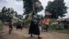 FILE - Residents of Bambo in Rutshuru territory, 60 kilometers north of Goma, the capital of North Kivu province, eastern Democratic Republic of Congo, flee as the M23 attacked the town, Oct. 26, 2023. 