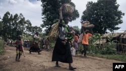 FILE - Residents of Bambo in Rutshuru territory, 60 kilometers north of Goma, the capital of North Kivu province, eastern Democratic Republic of Congo, flee as the M23 attacked the town, Oct. 26, 2023. 