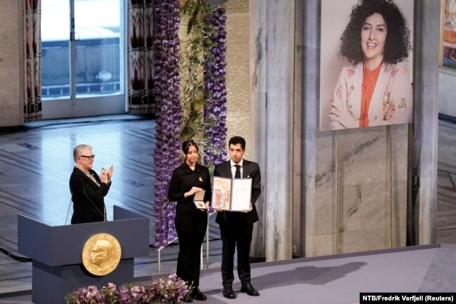 Ali and Kiana Rahmani, children of Narges Mohammadi, an imprisoned Iranian human rights activist, hold the Nobel Peace Prize 2023 award, accepting it on behalf of their mother at Oslo City Hall, Norway, Dec. 10, 2023.