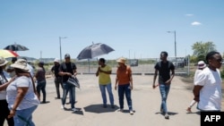 Family members of mineworkers staging an underground protest gather near the entrance of the Bakubung Platinum Mine in Ledig on December 8, 2023.