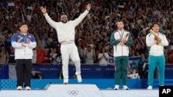 France's Teddy Riner celebrates his gold medal on the podium of the judo men's +100 kg event in the team judo competition, at Champ-de-Mars Arena, during the 2024 Summer Olympics, in Paris, France.