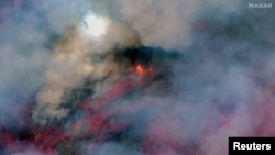 FILE - A color infrared satellite image shows flames and smoke rising from the Park Fire in Chico, California, July 26, 2024. (Maxar Technologies/Handout via Reuters)