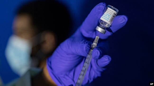 FILE - A nurse practitioner prepares a syringe with the Mpox vaccine before inoculating a patient at a vaccinations site in the Brooklyn borough of New York City, Aug. 30, 2022.
