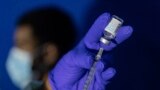FILE - A nurse practitioner prepares a syringe with the Mpox vaccine before inoculating a patient at a vaccinations site in the Brooklyn borough of New York City, Aug. 30, 2022.