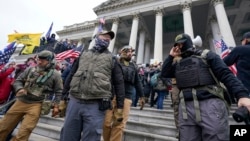 FILE - Members of the Oath Keepers stand outside the U.S. Capitol on Jan. 6, 2021, in Washington. Members David Moerschel and Joseph Hackett, both of Florida, were sentenced to prison June 2, 2023, for their roles in the attack on the Capitol. 