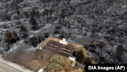 FILE - An aerial shot shows part of the extinguished wildfire area at the Anzac Cove beach on the Gallipoli peninsula, the site of the 1915 World War I landing of the Australian and New Zealand Army Corps, near Canakkale, Turkey, Aug. 16, 2024. (DIA Images via AP).