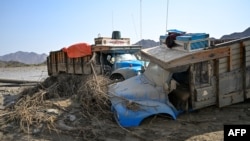 Damaged trucks are seen buried in the mud after the collapse of the Arbaat Dam, 40km north of Port Sudan following heavy rains and torrential floods, Aug. 25, 2024. 