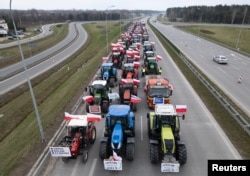 A drone view of farmer's tractors blocking a speedway from Lublin to Warsaw, as they protest against the European Union's Green Deal and imports of Ukrainian agricultural products, on the outskirts of Warsaw in Wiazowna, Poland, March 6, 2024.