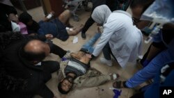 Palestinians wounded in the Israeli bombardment of the Gaza Strip are brought to Al Aqsa hospital in Deir al Balah, Gaza Strip, Jan. 7, 2024.