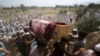 FILE - Relatives and mourners carry the casket of a victim, who was killed in a suicide bomber attack in the Bajaur district of Khyber Pakhtunkhwa, Pakistan, July 31, 2023.