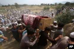 Relatives and mourners carry the casket of a victim, who was killed in Sunday's suicide bomber attack in the Bajaur district of Khyber Pakhtunkhwa, Pakistan, July 31, 2023.