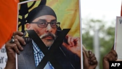 A protester holds a photo of Gurpatwant Singh Pannun during a rally in New Delhi, India, Sept. 24, 2023. U.S. officials said Nov. 22, 2023, that they had thwarted a conspiracy to assassinate Pannun in the U.S. and that they believe the Indian government was part of the attempt.