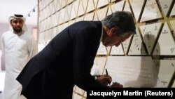 U.S. Secretary of State Antony Blinken writes on a tile at the Abrahamic Family House, in Abu Dhabi, United Arab Emirates, Oct. 14, 2023. He wrote “Light in the darkness” on the tile.