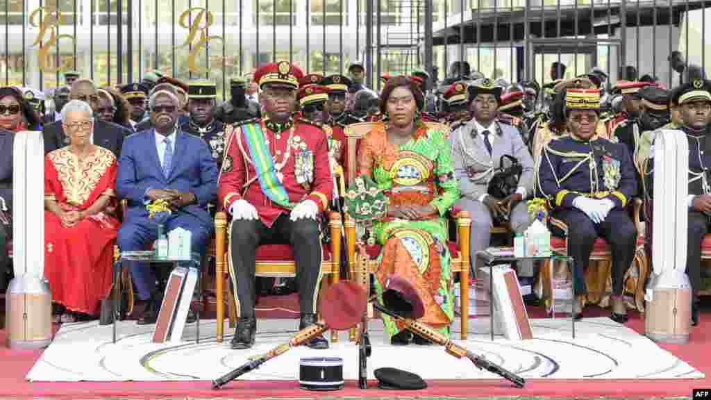 Transitional President of Gabon General Brice Oligui Nguema, front left, and his wife, Zita Nyangue Oligui Nguema, front right, attend the parade to mark the first anniversary of the military takeover in Libreville.