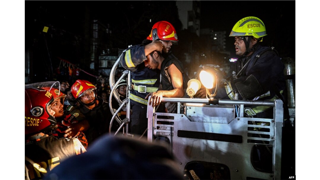 Firefighters extract victims after a fire race through a commercial building in Dhaka, Bangladesh, Feb. 29, 2024.