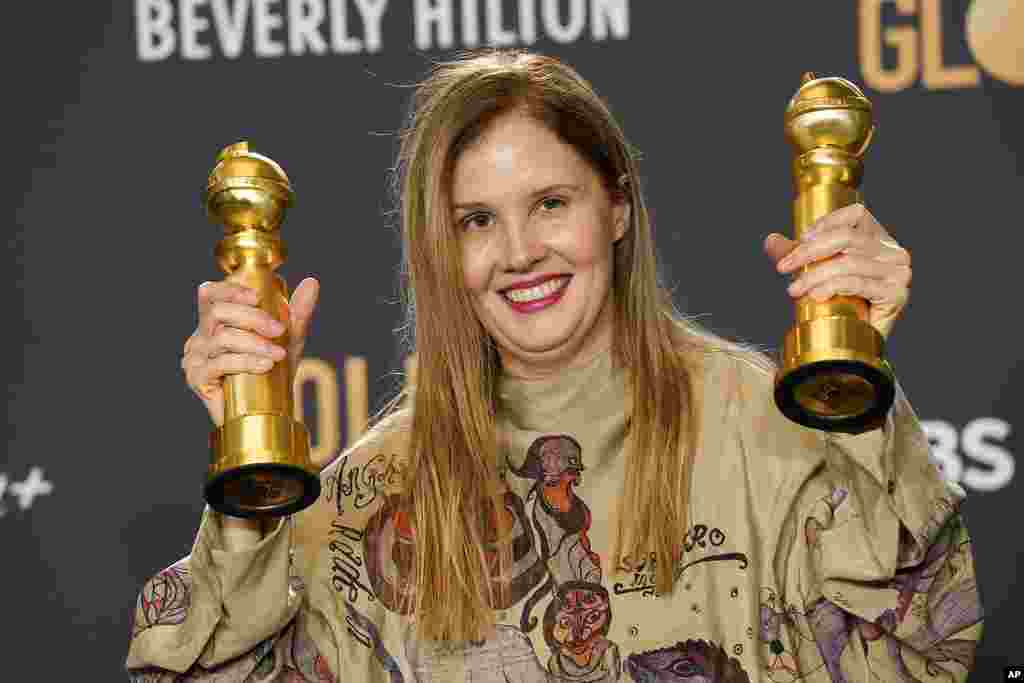 Justine Triet poses with the awards for best screenplay, motion picture for &quot;Anatomy of a Fall&quot; and for best motion picture, foreign language for &quot;Anatomy of a Fall&quot; in the press room at the 81st Golden Globe Awards on Jan. 7, 2024.
