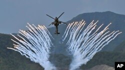 South Korea&#39;s Apache AH-64 helicopter fires flares during a South Korea-U.S. joint military exercise at Seungjin Fire Training Field in Pocheon, South Korea.