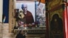 In this photo taken on December 9, 2015, a man prays below a portrait of the Dalai Lama at Kirti Monastery in Aba