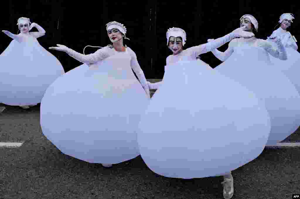 Artists pose as they attend the parade of the 151th edition of the Nice Carnival, in Nice, south-eastern France.