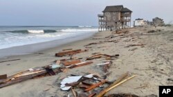 Esta foto proporcionada por el Servicio de Parques Nacionales el viernes 16 de agosto de 2024 en Rodanthe, Carolina del Norte, muestra los escombros de una casa de playa que se derrumbó en el océano Atlántico debido a los vientos y las olas causadas por el huracán Ernesto.