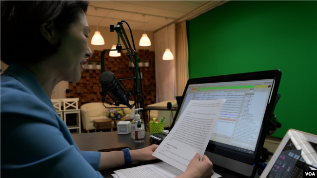 DKNet President Stephanie Min Kim reads the news on KKDA AM 730, a Dallas-area Korean language radio station. (Jonathan Zizzo for VOA)