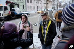 Activists speak to members of the media near the Russian Supreme Court after a hearing in Moscow, Russia, Nov. 30, 2023.