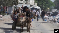Palestinians flee from northern Gaza to the south after the Israeli army issued an unprecedented evacuation warning to a population of more than 1 million people in northern Gaza, Oct. 13, 2023.