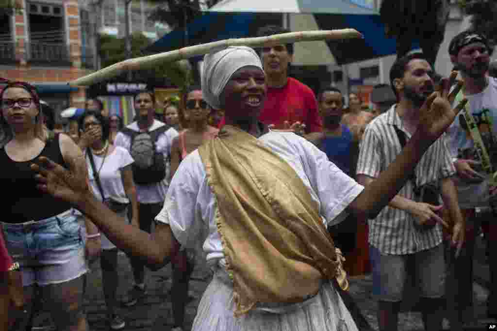 A reveler dances during a pre-carnival &quot;Piratas do Axe&quot; street party, in Rio de Janeiro, Brazil.