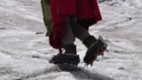 FILE - Aymara climbing guide Suibel Gonzales walks on the Huayna Potosi glacier near El Alto, Bolivia, Nov. 5, 2023. 