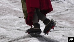 FILE - Aymara climbing guide Suibel Gonzales walks on the Huayna Potosi glacier near El Alto, Bolivia, Nov. 5, 2023. 