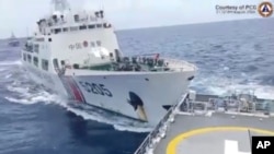 In this image taken from handout video provided by the Philippine Coast Guard, a Chinese Coast Guard ship, right, collides with Philippine Coast Guard vessel BRP Teresa Magbanua near the Sabina Shoal at the disputed South China Sea on Aug. 31, 2024.