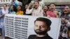 Members of a civil society group hold a banner with the picture of Pakistani human rights lawyer Jibran Nasir during a demonstration to condemn his abduction, in Karachi, Pakistan, June 2, 2023.